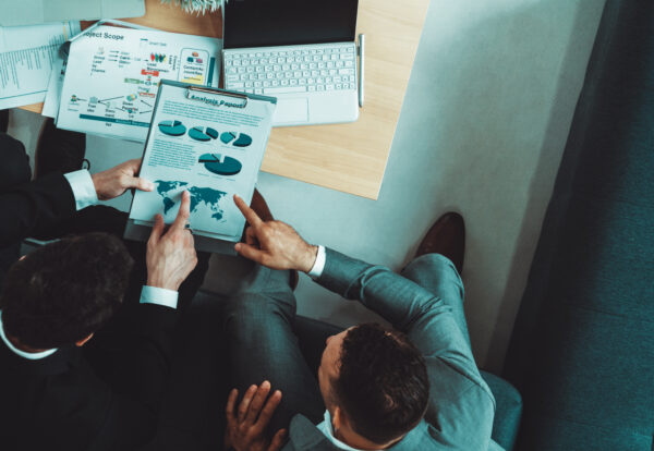 Businessman is in meeting discussion with another businessman partner in modern workplace office. People corporate business team concept. uds